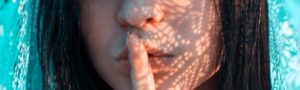 4 ways to add wow to your writing without words woman with finger on lips